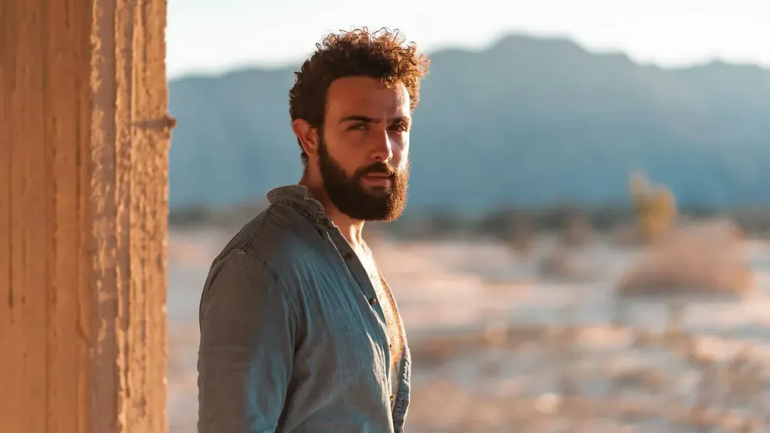 Before: a man with curly hair and a full beard