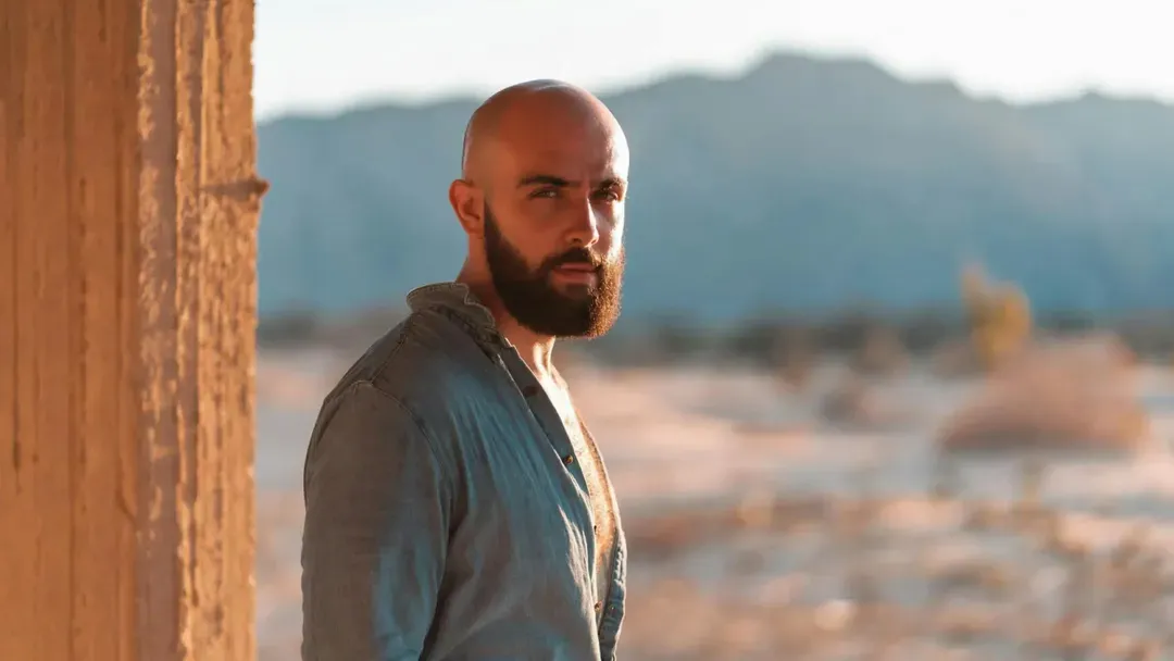 After: the same man with a bald head and his beard kept