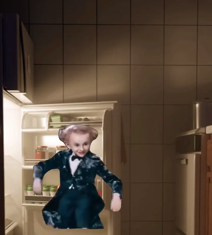 The little man cut out and placed in front of a fridge at night, arms open