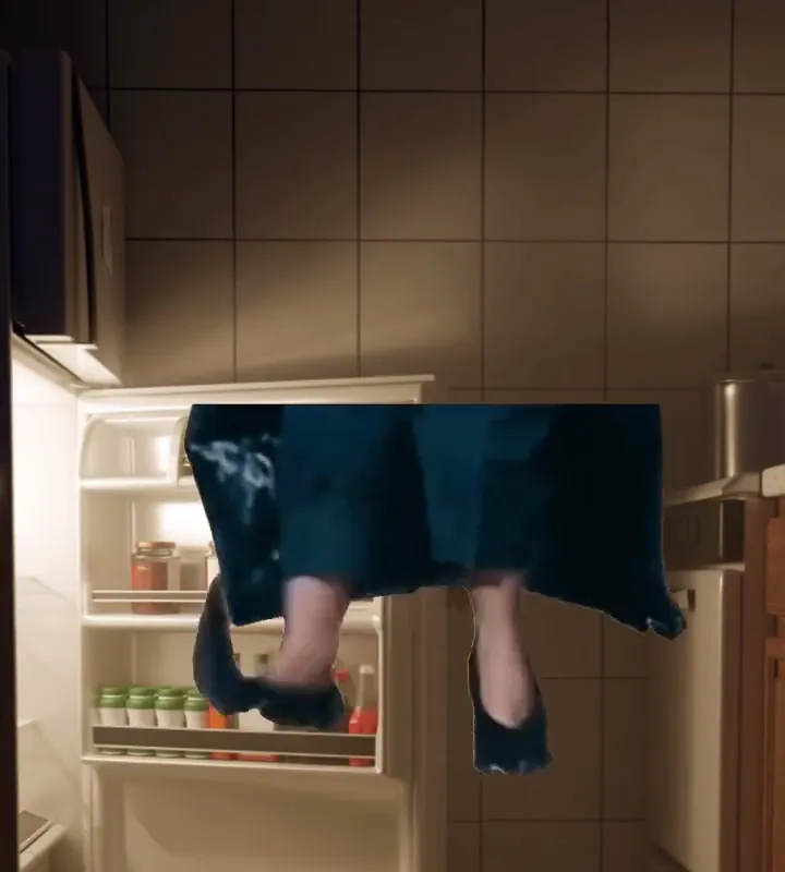 Feet tiptoeing in front of the fridge at night